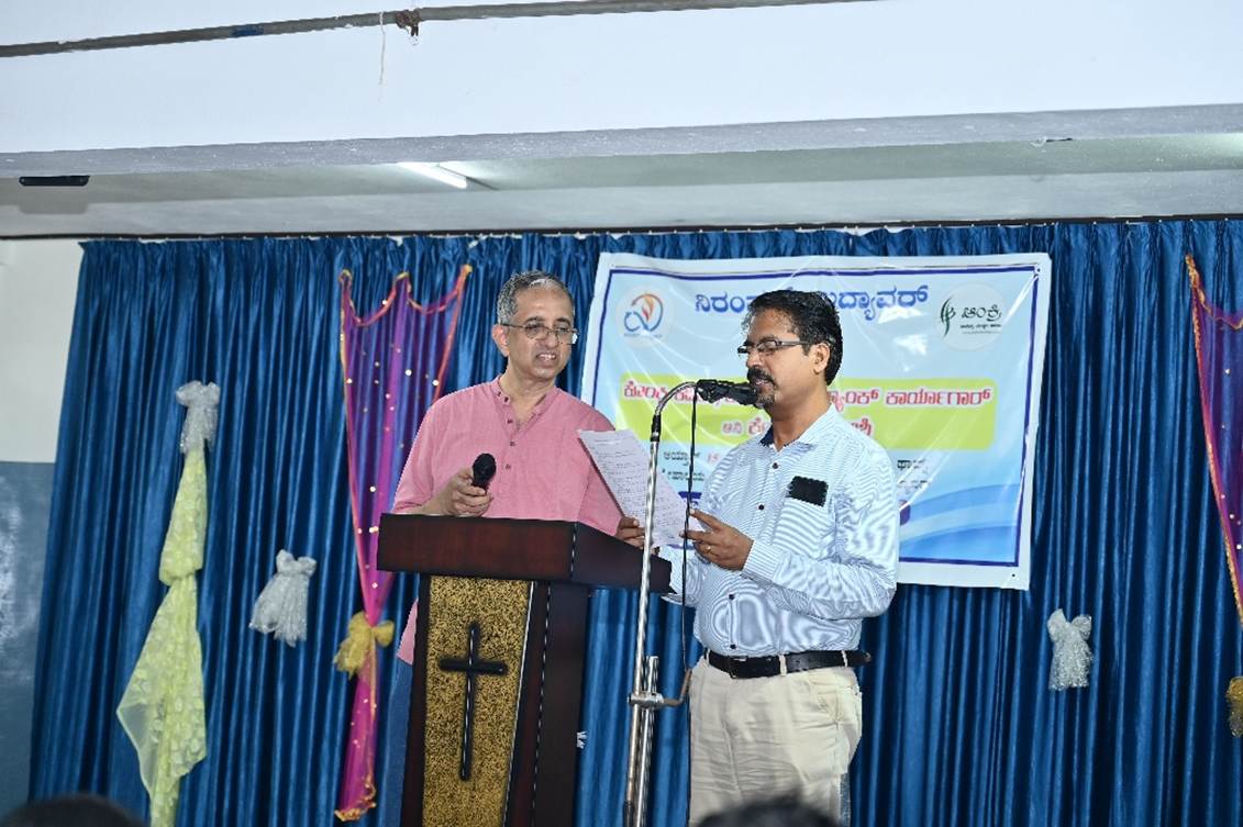 A person standing at a podium with a microphone and a person standing at a podium

AI-generated content may be incorrect.